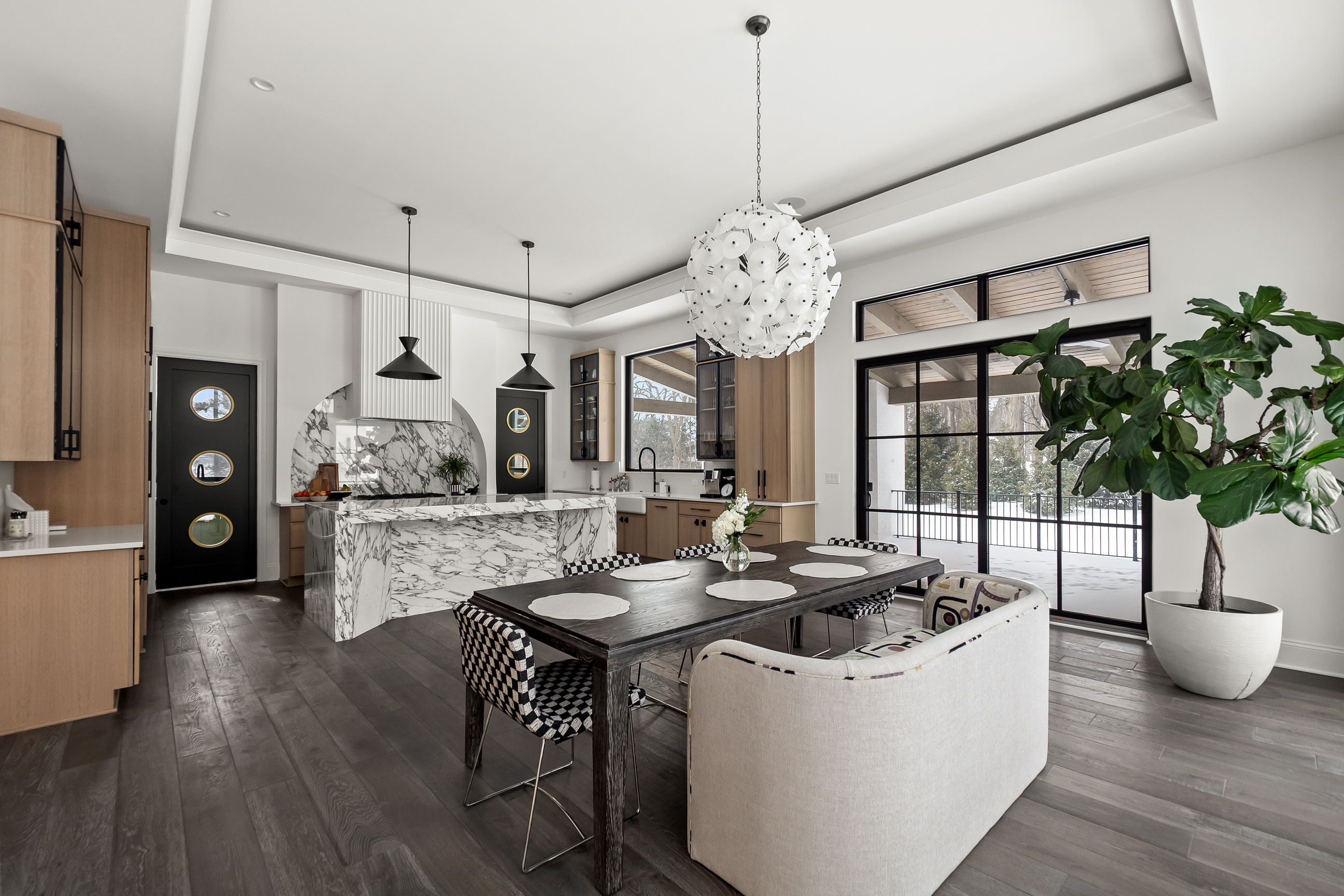Modern open kitchen with marble island, dining table