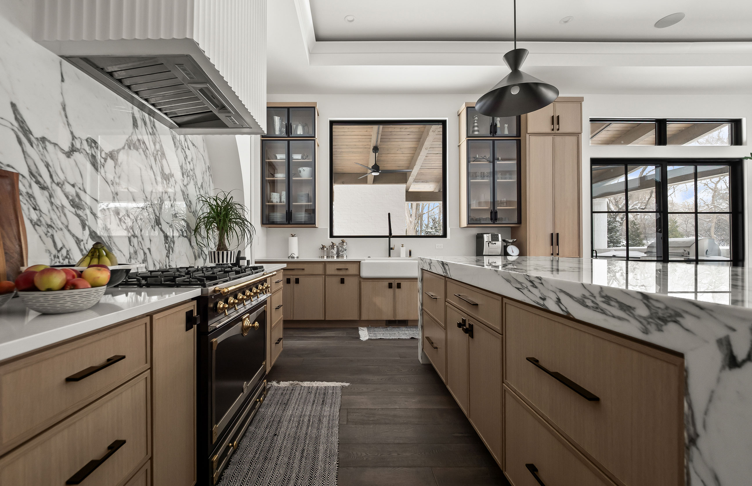 Modern kitchen with marble countertops and island