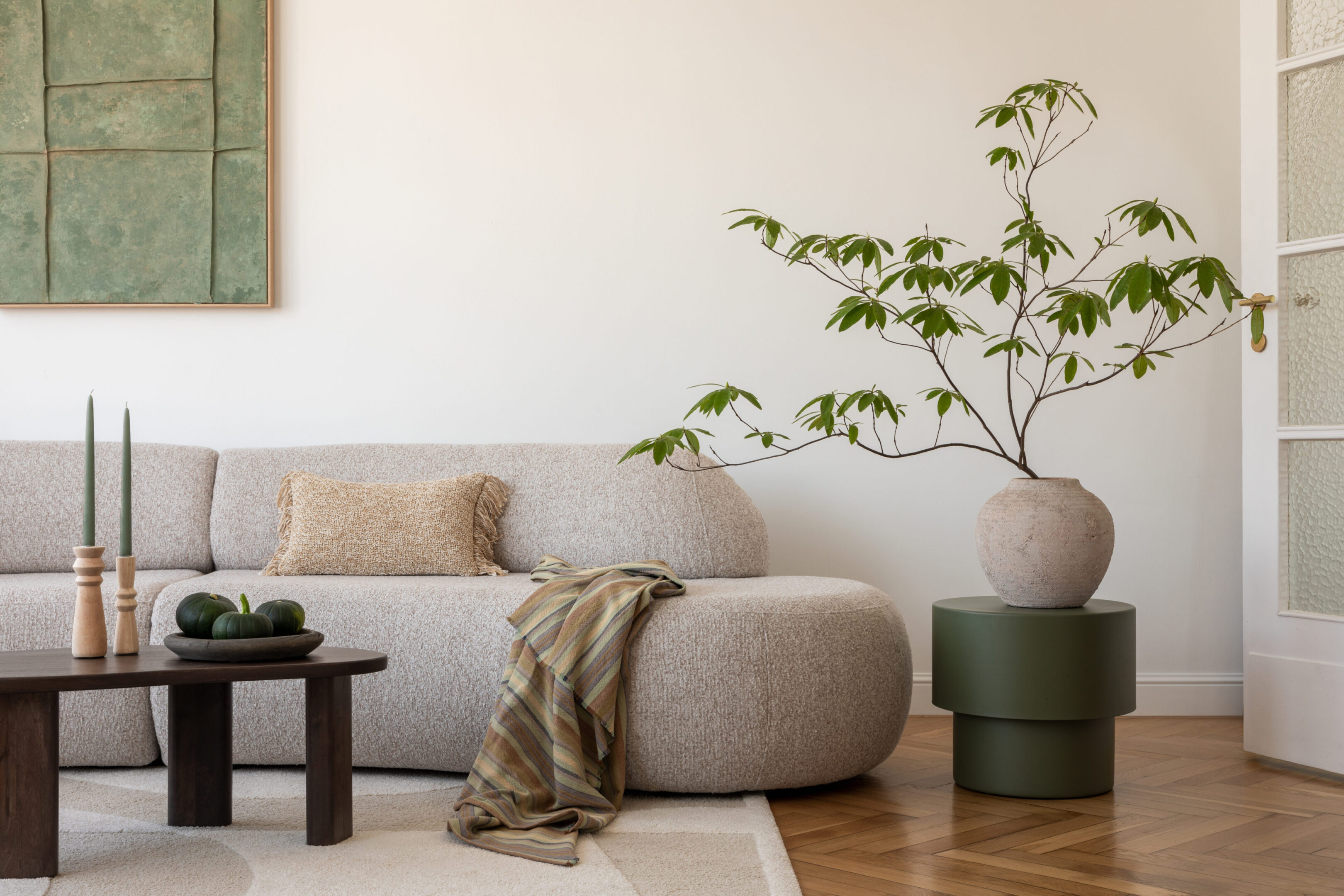 Minimal living room with sofa, ottoman, plant