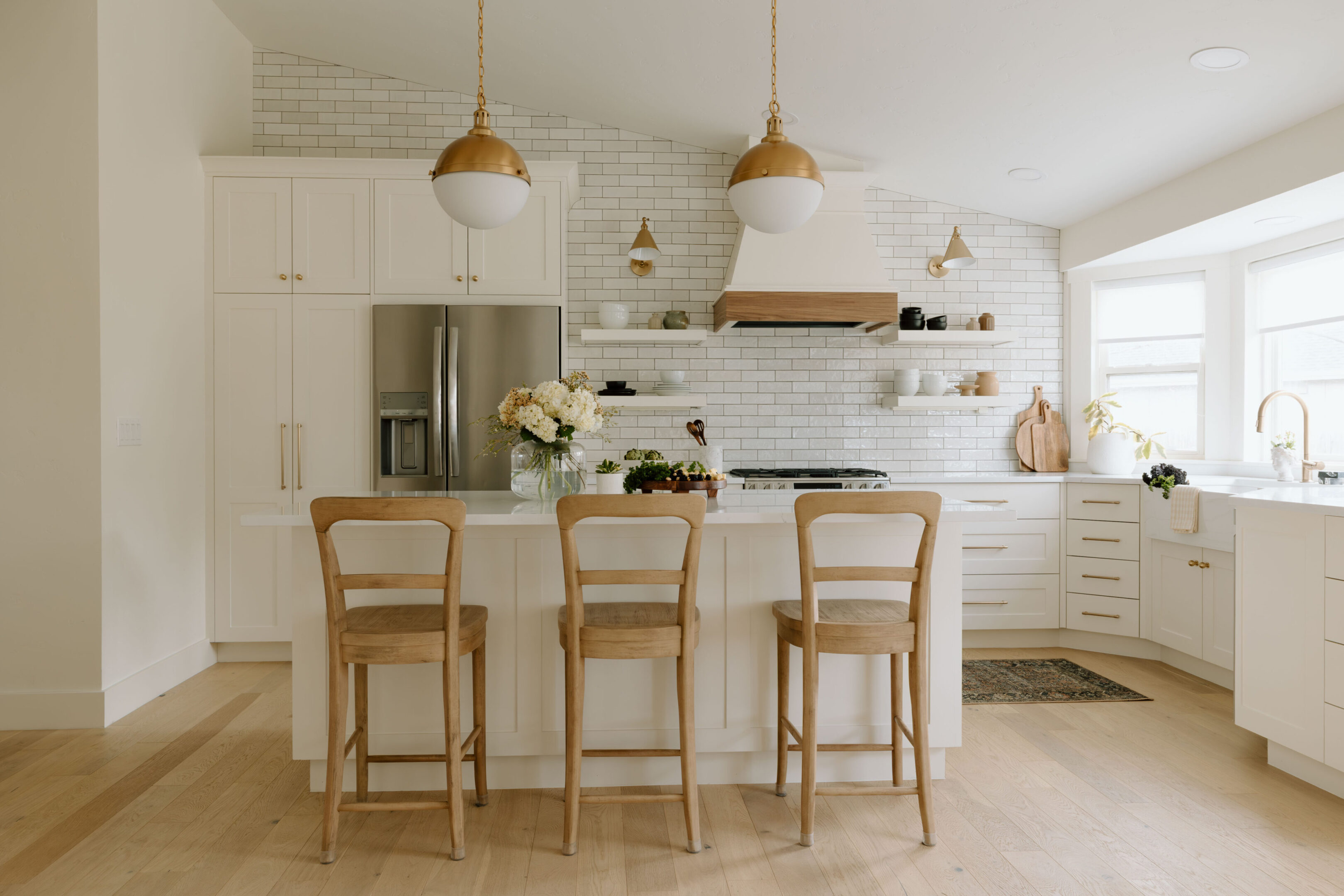 White modern kitchen island with three stools